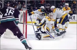  ?? YANNICK PETERHANS —THE ASSOCIATED PRESS ?? The Ducks' Ryan Strome bats the puck at Predators goalie Kevin Lankinen on Sunday.