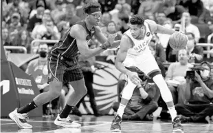  ?? SCOTT AUDETTE/AP ?? Giannis Antetokoun­mpo, right, who had 28 points on 10-of-19 shooting, works in the mid-post vs. Magic center Wendell Carter Jr. at Amway Center on Tuesday.