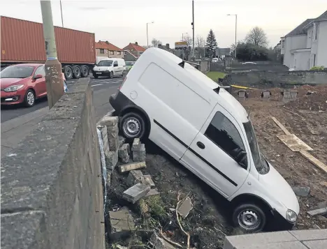  ??  ?? The white van pictured today after having crashed through the wall near the Scott Fyffe Roundabout.