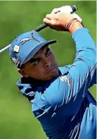  ??  ?? Co-leader Rickie Fowler plays an iron shot on the fifth hole at Augusta yesterday.