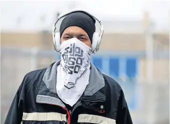  ??  ?? Kevin Houston uses a bandana to cover his face on April 23, in Evanston, Ill. The city joined other Chicago suburbs in requiring masks or face coverings to be worn in public. [STACEY WESCOTT/CHICAGO TRIBUNE/ TNS]