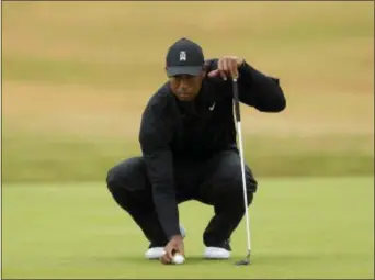  ?? THE ASSOCIATED PRESS ?? Tiger Woods of the US prepares to putt on the third green during Friday’s second round of the British Open.