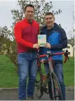  ??  ?? Pat McCarrick of Sligo Greenway Co-op present Darragh Sherwin with his prize of a trip to Waterford Greenway.