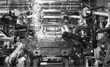  ??  ?? This file photo shows Chevy Volt electric vehicles and Opel Amperas going through assembly at the General Motors Detroit Hamtramck Assembly Plant in Hamtramck, Michigan. French carmaker PSA Peugeot Citroen said that revenues grew strongly in the third...