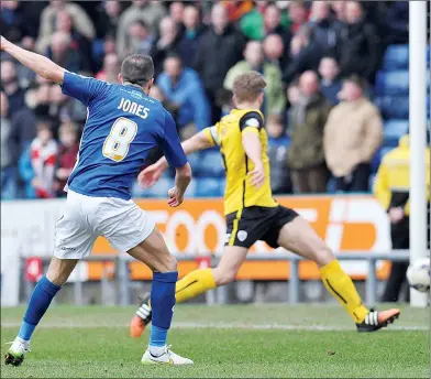  ??  ?? CONSOLATIO­N: Oldham’s Mike Jones scores his side’s only goal of the game shortly before half-time