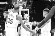  ??  ?? Kevin Durant (left) celebrates with Stephen Curry (centre) of the Golden State Warriors during the second half against the Cleveland Cavaliers in Cleveland. - AFP photo