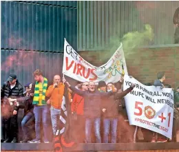  ?? — AP ?? Fans hold up banners as they protest against the Glazer family, the owners of Manchester United, before their Premier League match against Liverpool at Old Trafford in Manchester on Sunday.