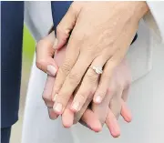  ?? DOMINIC LIPINSKI / PA VIA AP ?? Meghan Markle wears her engagement ring as she poses with Britain’s Prince Harry on Monday.