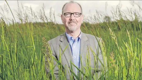  ?? WARD PERRIN ?? Kent Mullinix, Kwantlen University’s Institute for Sustainabl­e Food Systems director, argues that developmen­t pressure fuelled by land exclusions for housing and other uses have driven B.C. farmland prices so high that farmers can’t buy it and expect...