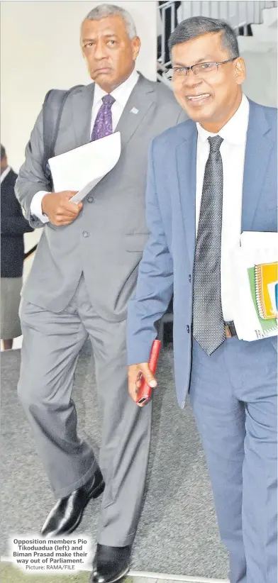  ?? Picture: RAMA/FILE ?? Opposition members Pio Tikoduadua (left) and Biman Prasad make their way out of Parliament.