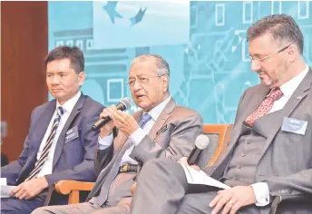  ?? Bernama photo ?? Dr Mahathir (centre) is seen during a dialogue session organised by the Malaysian French Chamber of Commerce and Industry with CCI France Malaysia chairman Datuk Zainal Amanshah (left) and president Gilles Waeldin (right). —