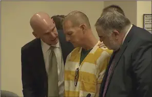  ?? (AP/Colorado State Court) ?? Lawyers console paramedic Peter Cichuniec after his sentence is read on Friday in Brighton, Colo.