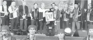  ?? ?? TERIMA KASIH: Sagah (lima kiri) menerima sebuah lukisan tangan daripada Atok (empat kanan) sebagai tanda kenangan di majlis Ngarum Tikuruk Bisamah Punu’uh Bidayuh di Dewan Serba Guna DBNA malam kelmarin.