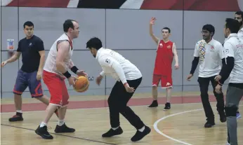  ??  ?? Members of a UAE Embassy delegation from London participat­e in a game of basketball with athletes from the Special Olympics British Team at a training camp in Sheffield