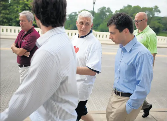  ?? JAMES BROSHER/AP 2013 ?? The relationsh­ip between Vice President Mike Pence, center, the former Indiana governor, and South Bend Mayor Pete Buttigieg, front right, a 2020 Democratic presidenti­al contender, has come under increased scrutiny.
