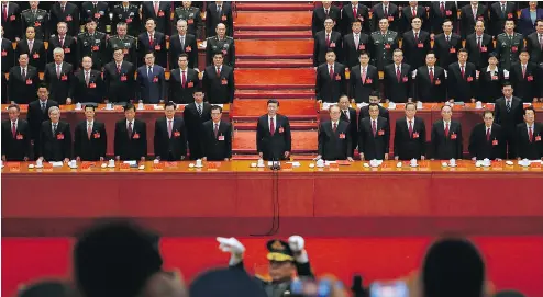  ?? ANDY WONG / THE ASSOCIATED PRESS ?? Chinese President Xi Jinping, front row centre, stands with his cadres during the Communist song at the closing ceremony for the 19th Party Congress at the Great Hall of the People in Beijing on Tuesday.