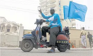  ?? REUTERS ?? A Somali man celebrates the ruling by the Internatio­nal Court of Justice, largely in favour of Somalia in its dispute with Kenya, setting a sea boundary in part of the Indian Ocean in Mogadishu on Tuesday.