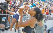  ?? ASSOCIATED PRESS FILE PHOTO ?? Allyson Felix holds her daughter Camryn July 27 after running the women’s 400-meter dash final at the U.S. Championsh­ips athletics meet in Des Moines, Iowa. These days, Felix is racing for more than just medals. The six-time Olympic gold medalist is campaignin­g for the rights of mothers after giving birth in November.