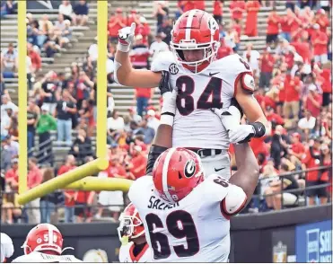  ?? Christophe­r Hanewincke­l ?? Georgia Bulldogs wide receiver Ladd McConkey (84) celebrates with Georgia Bulldogs offensive lineman Jamaree Salyer (69) after a touchdown during the first half against the Vanderbilt Commodores at Vanderbilt Stadium.