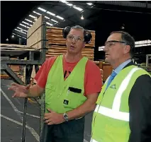  ?? PHOTO: PIERS FULLER/FAIRFAX NZ ?? JNL Masterton mill manager Paul Jordan shows then-prime Minister John Key around the plant in 2015.