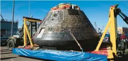  ?? NASA/KIM SHIFLETT ?? Team members with NASA’s Exploratio­n Ground Systems program successful­ly removed the Artemis I Orion spacecraft from the USS Portland Dec. 14, after the ship arrived at U.S. Naval Base San Diego.