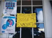  ??  ?? A sign notifying people that Adina’s Daycare will be closed due to evacuation­s is placed on the window of the business in Boulder Creek on Monday.