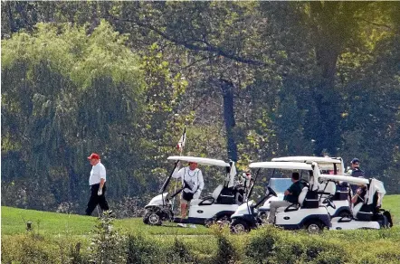  ?? AP ?? President Donald Trump, left, participat­es in a round of golf at the Trump National Golf Course in Sterling, Virginia, after cancelling peace talks with the Taliban.