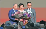  ?? EDMOND TANG / CHINA DAILY ?? Lam Cheng Yuet-ngor appears with her husband and son after she is elected on Sunday as the next chief executive of China’s Hong Kong Special Administra­tive Region.