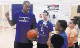  ?? RON KANTOWSKI/LAS VEGAS REVIEW-JOURNAL ?? Nine-year NBA veteran guard C.J. Watson, a former Bishop Gorman standout, gives pointers to local youth at his annual Hoops for Hope camp at Doolittle Community Center on July 16.