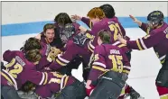  ?? SARAH GORDON/THE DAY ?? Eastern CT Eagles players pile on goalie Rylin Fowler after winning the Division III hockey championsh­ip game over Tri-Town on Saturday at Yale University’s Ingalls Rink. The Eagles won 7-3.