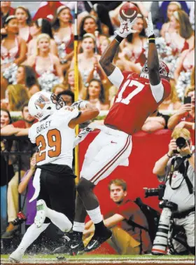  ?? Adam Hagy USA Today ?? Alabama wide receiver Cam Sims catches an 8-yard touchdown pass against Mercer cornerback Brandon Gurley in the third quarter of the No. 1 Crimson Tide’s 56-0 win Saturday.
