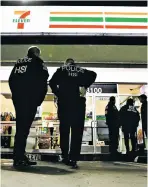  ?? CHRIS CARLSON/THE ASSOCIATED PRESS ?? U.S. immigratio­n agents serve an employment audit notice at a 7-Eleven convenienc­e store Wednesday in Los Angeles. About 100 7-Eleven stores were visited nationwide.