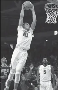  ?? Special to The Sentinel-Record/Craven Whitlow ?? SOARING: Arkansas freshman Daniel Gafford skies for one of seven dunks Tuesday at Bud Walton Arena as he led the Razorbacks with 21 points and 10 rebounds in a 91-82 defeat of 14th-ranked Auburn. The Hogs have won seven of their last eight games.