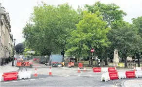  ??  ?? Roadworks in Bath’s Queens Square earlier this year being carried out in preparatio­n for the clean air zone, which had been due to start in November