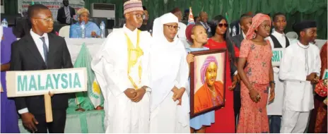  ?? Photo: FMOE ?? Students acting the role of President Muhammadu Buhari (middle) and his wife Aisha Buhari at the Commonweal­th Day Celebratio­n on Monday in Abuja