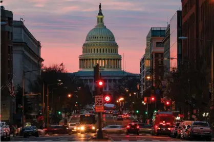  ?? Photograph: Tasos Katopodis/Getty Images ?? The US Capitol early on Monday morning. Most Americans can expect a $600 stimulus check from the government, half the amount distribute­d to individual­s in the spring.