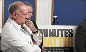  ?? Darrell Sapp/Post-Gazette ?? Dr. Donald M. Yealy, left, chair of emergency medicine at UPMC, and Public Safety Director Wendell Hissrich stand near the “Minutes Matter” poster Thursday during a news conference concerning an ad campaign.