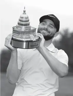  ?? Associated Press ?? Kyle Stanley holds the trophy after the Quicken Loans National golf tournament Sunday in Potomac, Md. Stanley won in a playoff.