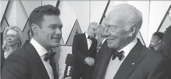  ?? E! ONLINE ?? Ryan Seacrest, left, interviews Canadian actor Christophe­r Plummer at the Oscar awards ceremony. But many other stars avoided Seacrest at Sunday’s event, following allegation­s of sexual misconduct.