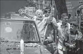  ?? THE NEW YORK TIMES ?? KUNI TAKAHASHI Narendra Modi, India’s next prime minister, greets supporters of his victorious Bharatiya Janata Party as he arrives in New Delhi.