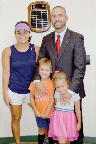  ?? TAMMY KEITH/RIVER VALLEY & OZARK EDITION ?? Circuit Judge Troy Braswell Jr. stands in the Conway Police Department with his wife, Karla, and their two children, Trey, 6, and Mia, 4. The plaque on the wall has Braswell’s name engraved as Outstandin­g Community Leader, presented to him June 29 by the Conway Morning Rotary Club.