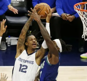  ?? Andy Clayton-king, The Associated Press ?? Memphis guard Ja Morant shoots against Minnesota guard Patrick Beverley during Friday night’s Western Conference playoff game.