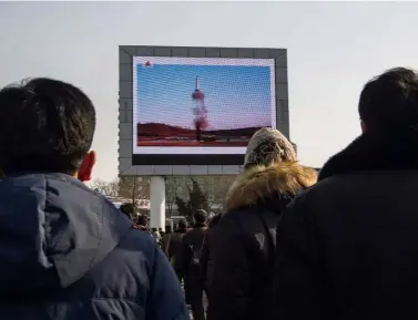  ?? — AFP ?? Serious threat: People in Pyongyang watching a public broadcast of a launch of the surface-tosurface medium longrange ballistic missile Pukguksong-2 at an undisclose­d location recently. Such missiles are capable of carrying a chemical weapon warhead.