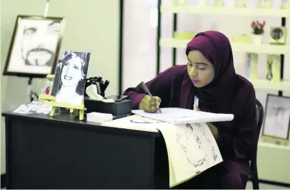  ?? Courtesy Zero Nine ?? Teenage pop artist Shamma Al Semihi puts pen to paper at the annual Zero Nine Exhibition in Fujairah.