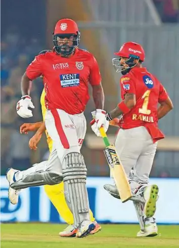  ?? AFP ?? Kings XI Punjab cricketer Chris Gayle (left) and Lokesh Rahul run during the IPL match in Mohali. The pair’s brisk start has been a big factor in Punjab’s success story so far.