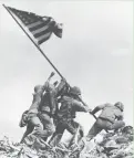  ?? AP ?? Associated Press photograph­er Joe Rosenthal records the moment when U.S. Marines raised a second American flag on Mount Suribachi during the battle for Iwo Jima on Feb. 23, 1945.