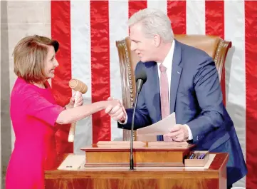  ??  ?? Pelosi (left) is handed the gavel by Kevin McCarthy (R-CA) after being elected as House Speaker as the US House of Representa­tives meets for the start of the 116th Congress inside the House Chamber on Capitol Hill. — Reuters photo