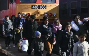  ?? ANNA SZILAGYI — THE ASSOCIATED PRESS ?? Refugees fleeing conflict from neighborin­g Ukraine arrive to Zahony, Hungary, on Sunday. Leaders in Poland, Hungary, Bulgaria, Moldova and Romania are offering a hearty welcome.