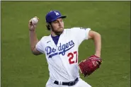  ?? MARK J. TERRILL — THE ASSOCIATED PRESS FILE ?? Los Angeles Dodgers starting pitcher Trevor Bauer warms up prior to a baseball game against the Colorado Rockies, April 13, 2021, in Los Angeles. Bauer was suspended Friday, April 29, 2022, for two full seasons without pay by Major League Baseball for violating the league’s domestic violence and sexual assault policy, which he denies.