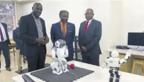  ?? ?? United States Ambassador to Jamaica N Nick Perry (centre) observes robots controlled by Damion Mitchell (left), assistant provost and chair of NCU’S CIS department. Looking on is NCU’S President Dr Lincoln Edwards.